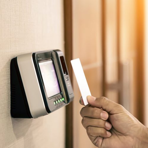 Proximity card reader door unlock, Hand security man using ID card on fingerprint scanning access control system for identity verification to open the door or for security safety or check attendance.